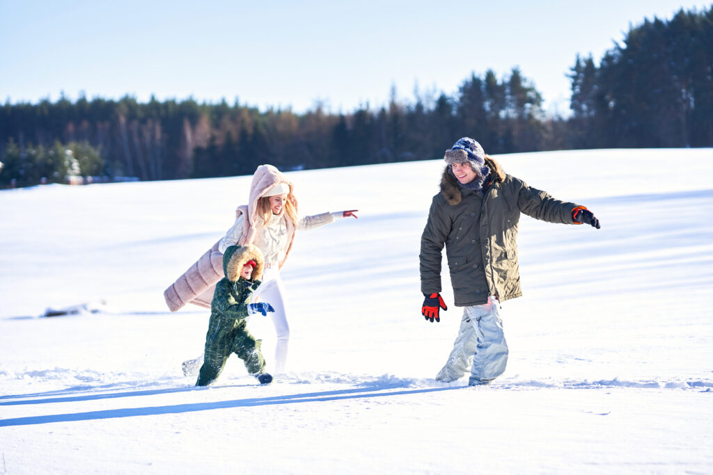 Nice happy family having fun on winter snow. High quality photo