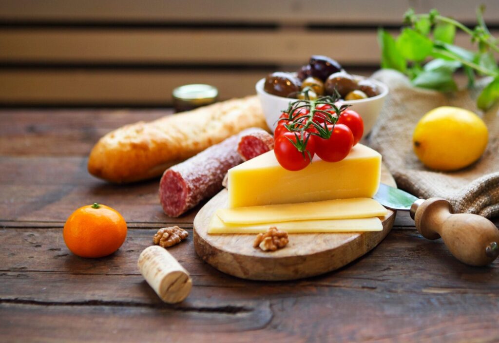 Italian food ingredients with olive oil on wooden background