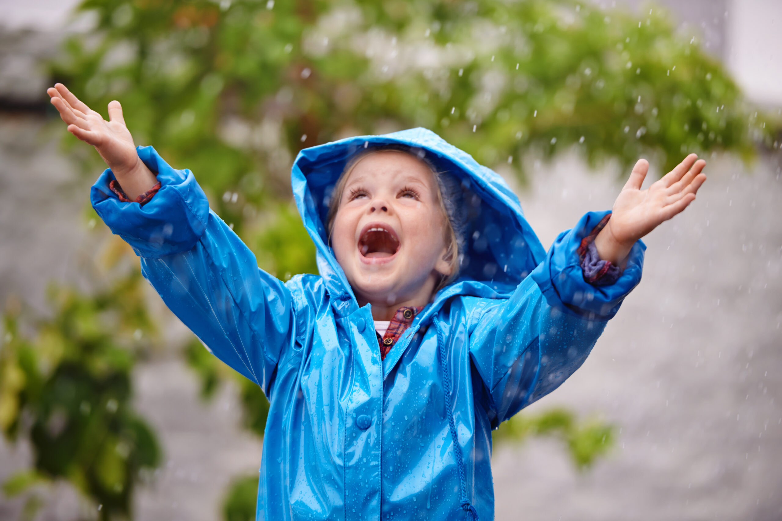 To enjoy the rainbow, first enjoy the rain. Shot of a young girl playing outside in the rain